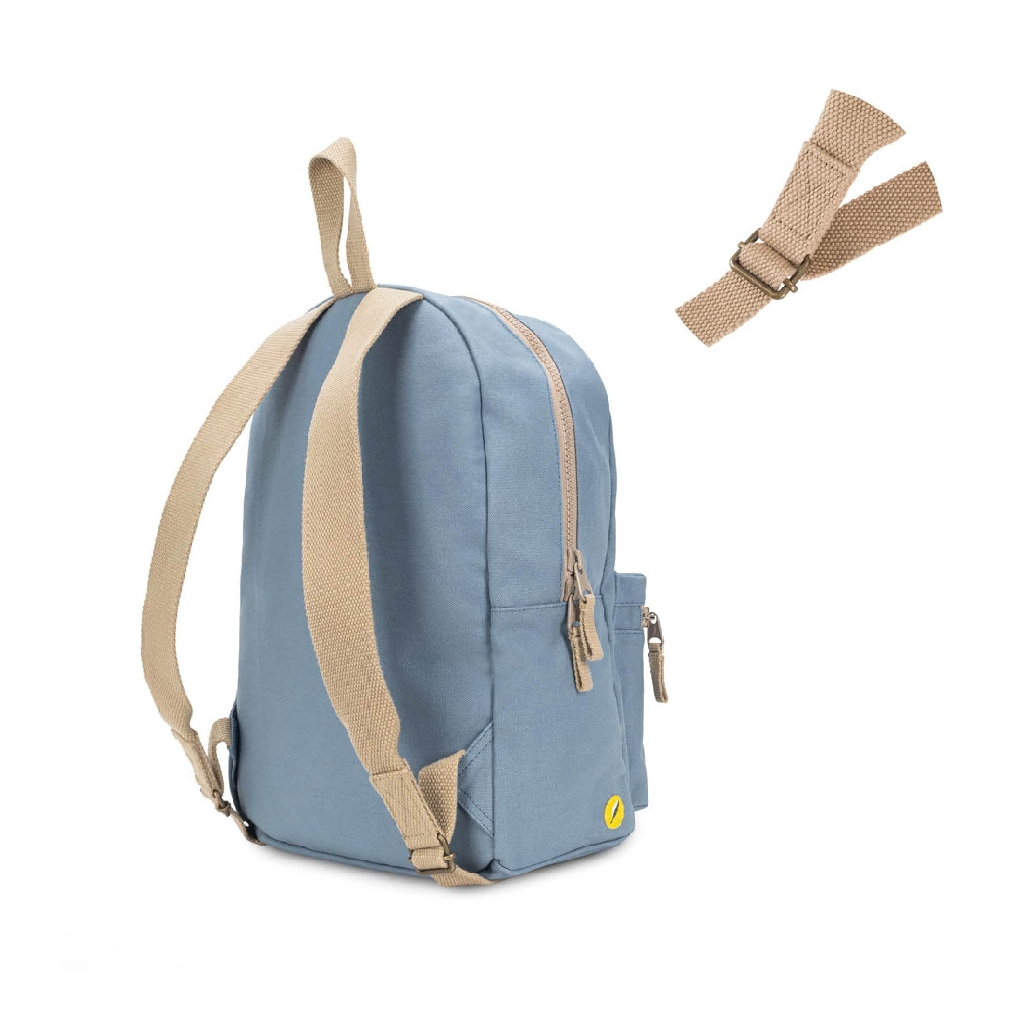 A light blue backpack with beige webbing straps and a small yellow logo, shown on a white background with an extra detachable strap floating to the upper right.