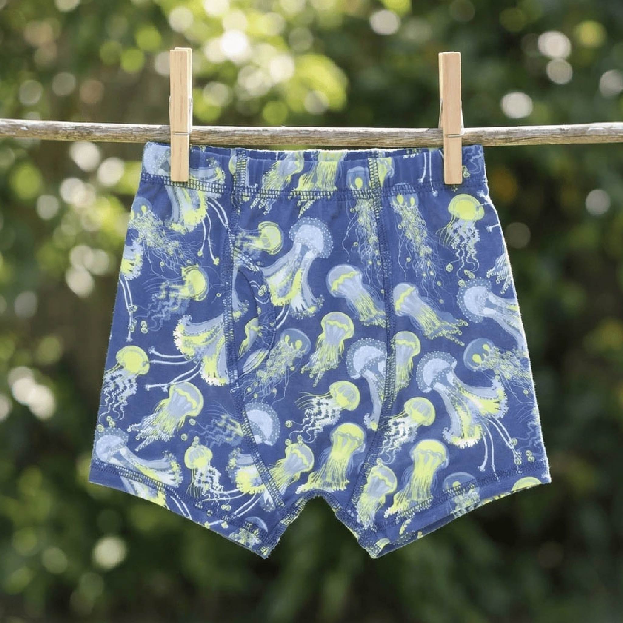 Boy wearing Sweet Bamboo Glow Zone bamboo trunks from the boys 3-pack, sizes 7Y and 8Y